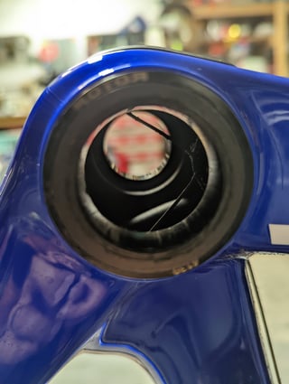 View through the bottom bracket showing the cable impinging on the axle