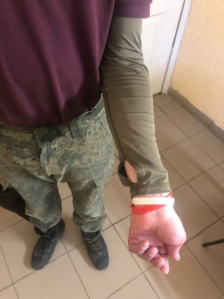 Allegedly, a russian soldier wearing color wristbands to indicate HIV and Hepatitis