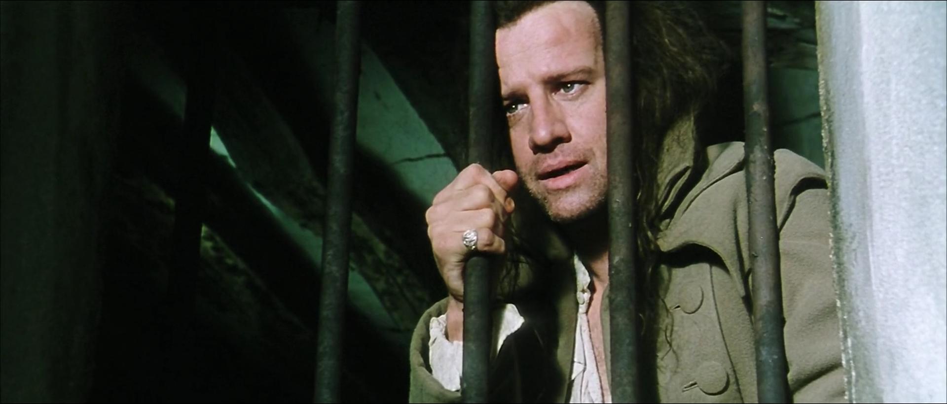 Image of Connor MacLeod in a prison cell, looking out through a window, from "Highlander III: The Sorcerer" (1994).