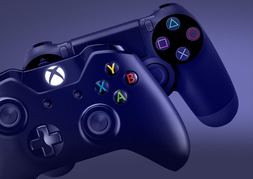 A photo of an Xbox One and a PlayStation 4 controller, showing their face buttons with prominent, colour-coded icons on each