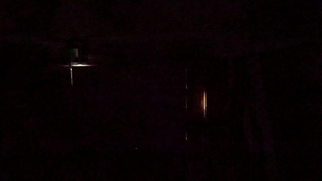 Sunlight coming through the top left of the garage door, lights are OFF inside