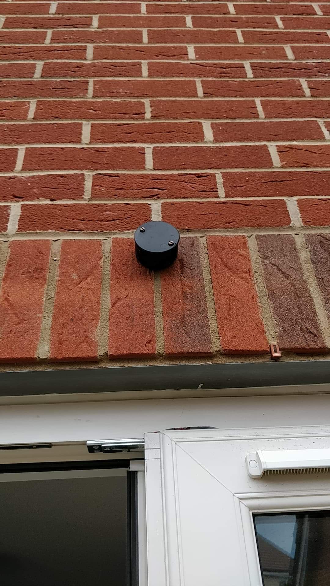 black cylindrical object attached to exterior wall