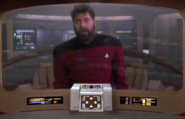 Riker stares out of the viewscreen from an empty bridge; his beard is long and his hair is messy; he looks stunned or shell-shocked