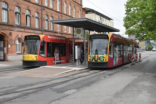 Nordhausen tram cars at the station square stop; one going back to town, the other bound for Ilfeld with its pantograph retracted