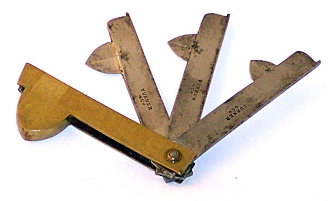 Fleam, three steel blades in brass housing, by Turner