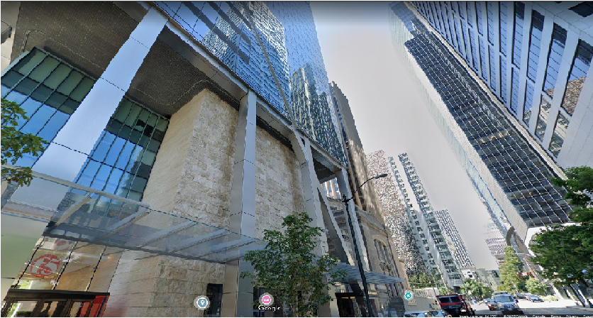 An angled view of the façade of the F5 building in Seattle, with a view of buildings directly nearby