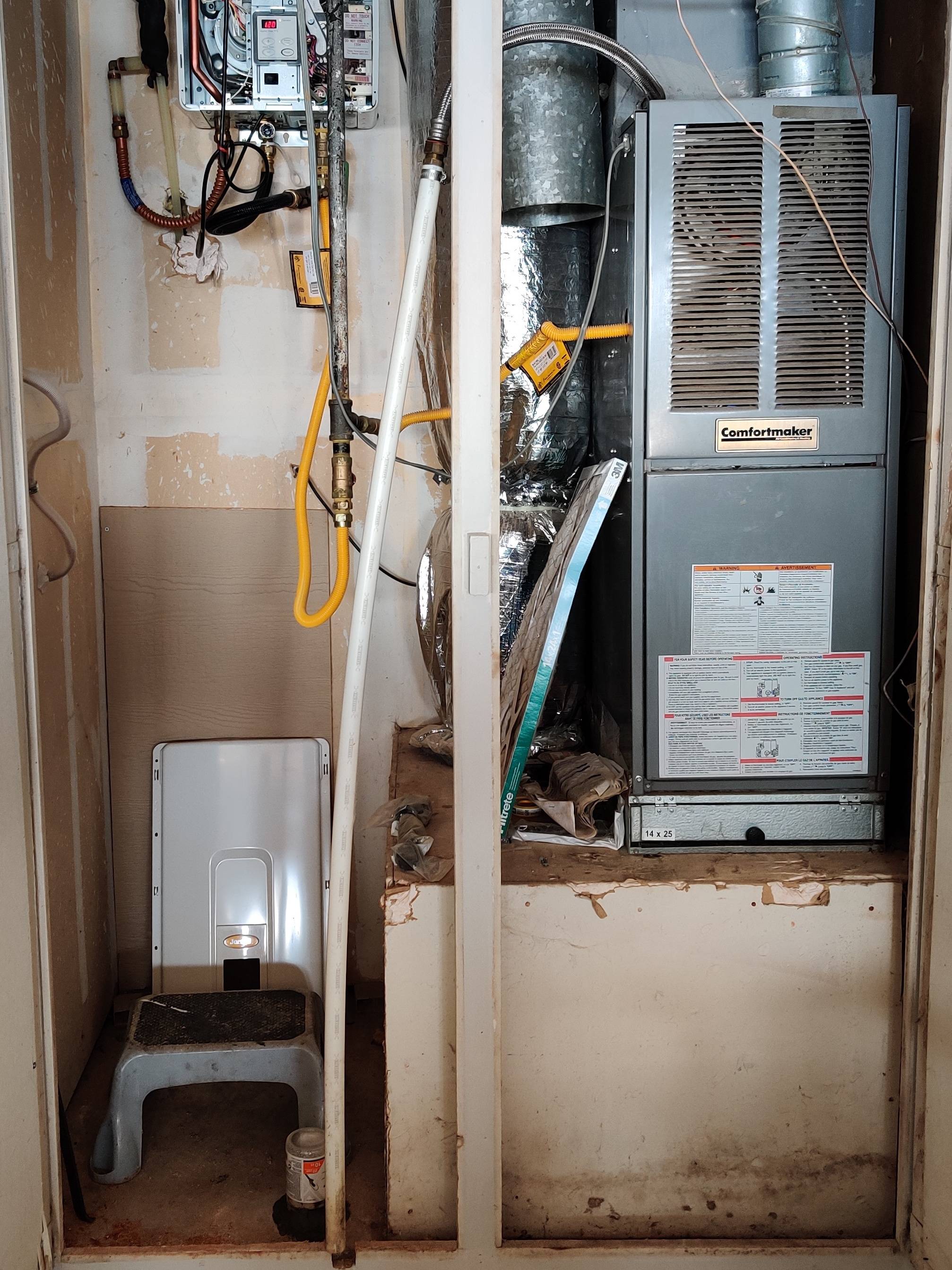 picture of a utility closet with tankless water heater and gas furnace and central A/C