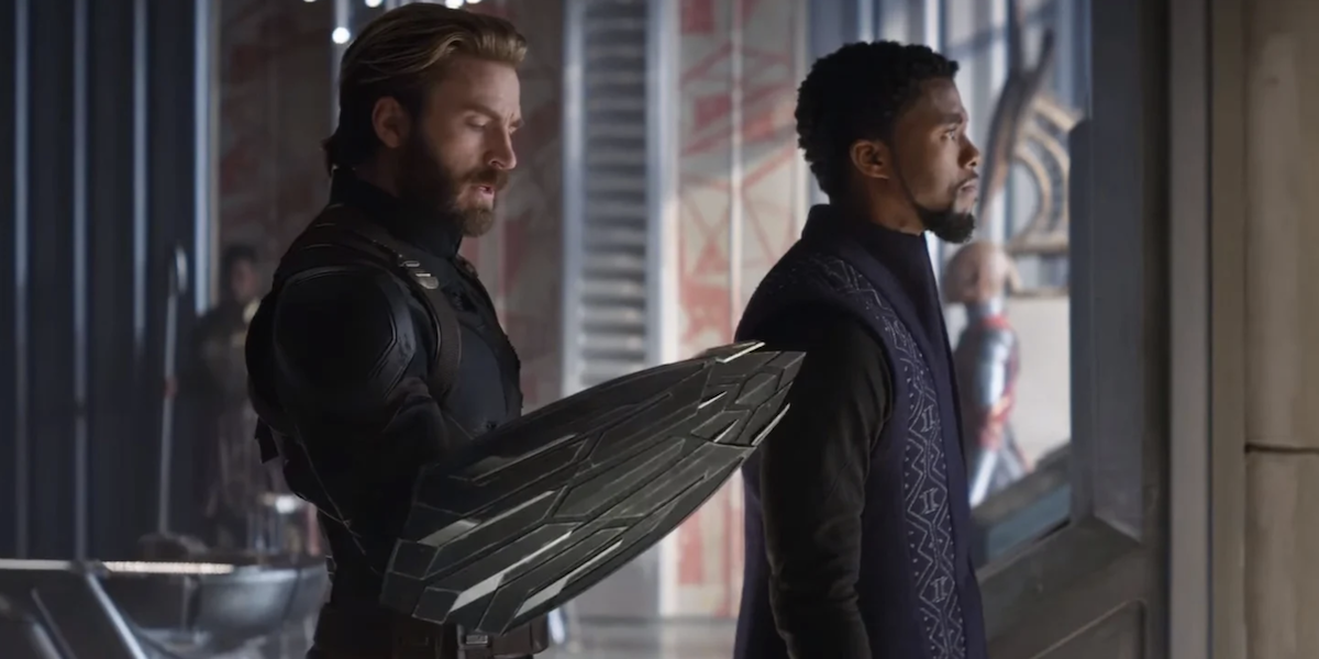 Steve inspects the new shield on his arm whilst standing next to T’Challa