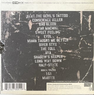 The reverse side of a UK & Europe version of Beat the Devil’s Tattoo, showing the same thirteen tracks as the above image, but with two bonus tracks including “1:51”.