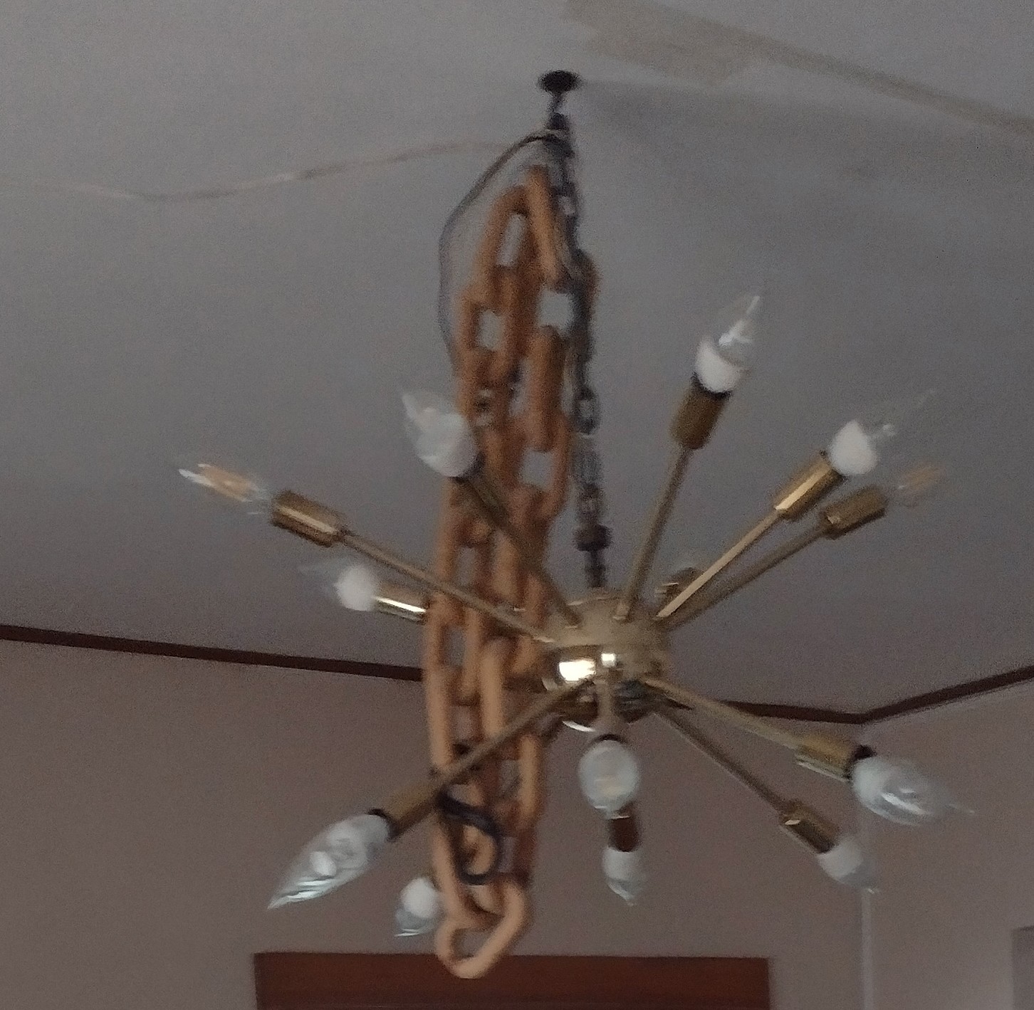 light fixture hung from ceiling hook as swage lamp