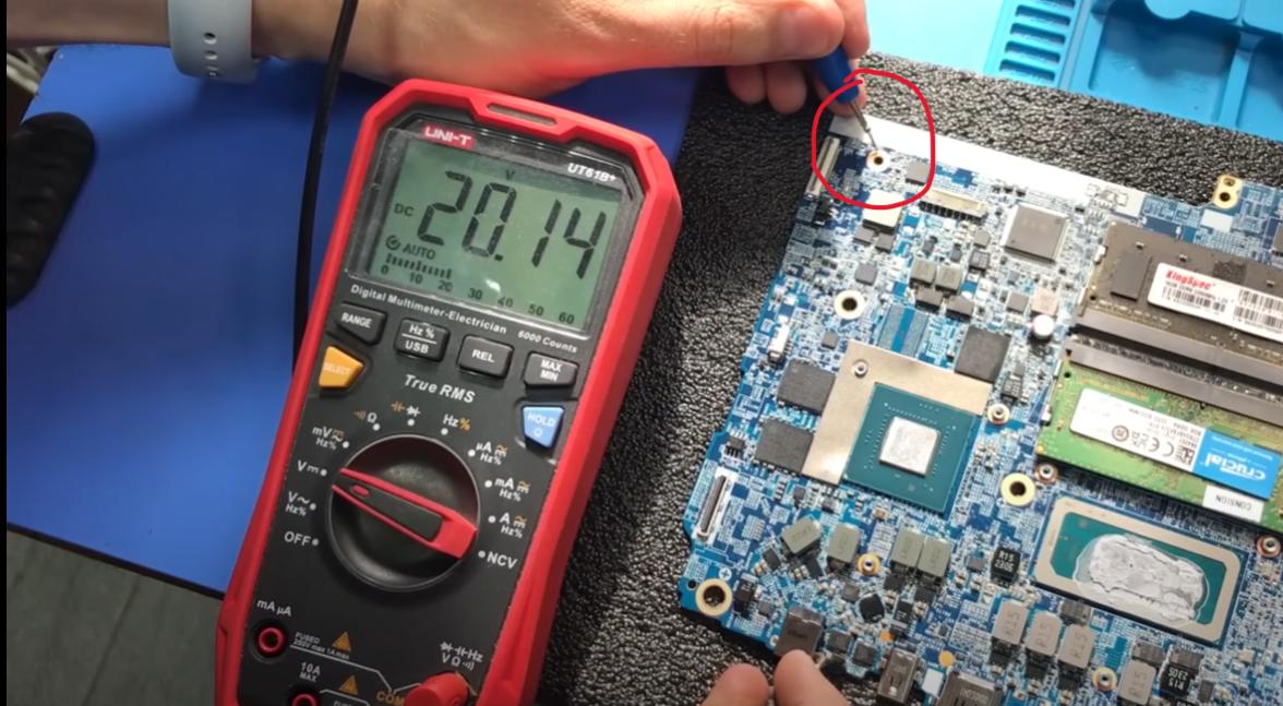 A technician uses the multimeter to test different components of the motherboard