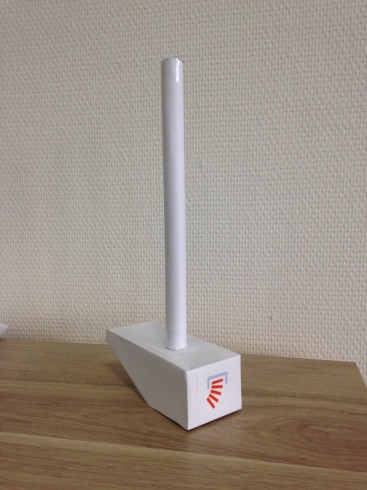 An upside-down wooden hammer painted white with a round Stack Overflow sticker on the front of the hammer