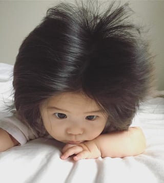 infant with a mop of thick black hair