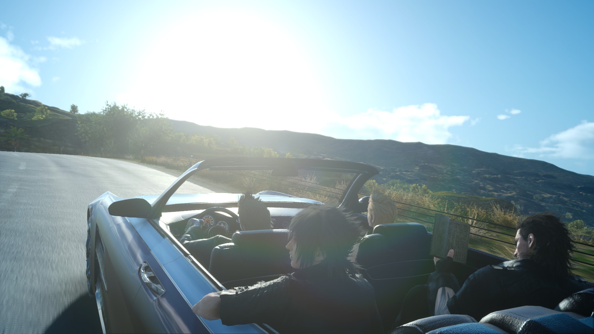 A screenshot from Final Fantasy XV. Ignis is driving through a beautiful sunny day with clear blue sky, whilst Prompto is watching the road on the passenger seat. Noctis, leaning against the edge of the car in back behind Ignis is looking off to the left, whilst Gladolius is reading a book behind Prompto.