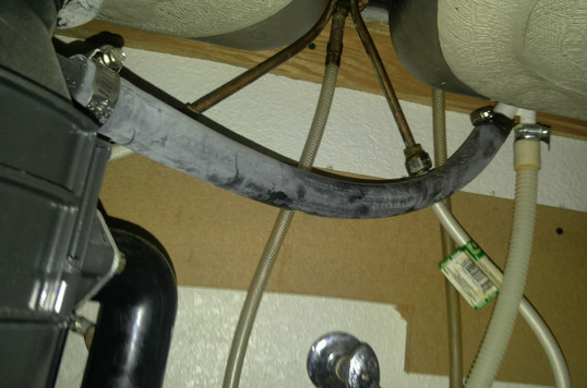 Photo 1 with dishwasher hose leading to garbage disposal