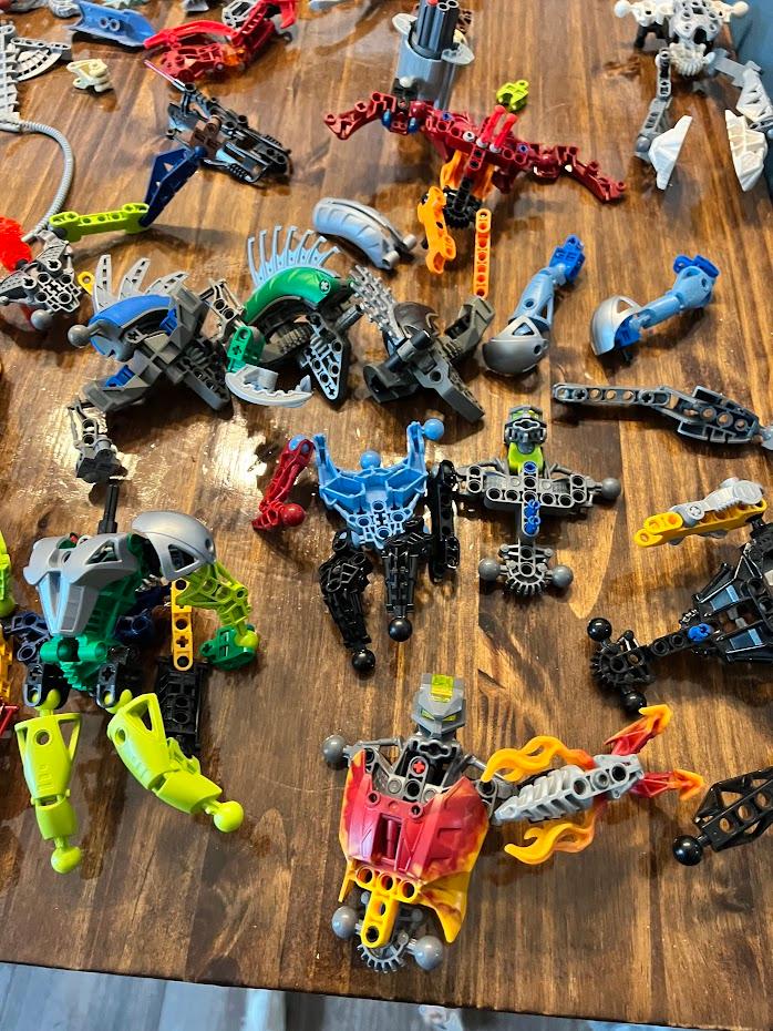 several disassembled bionicles and spare parts