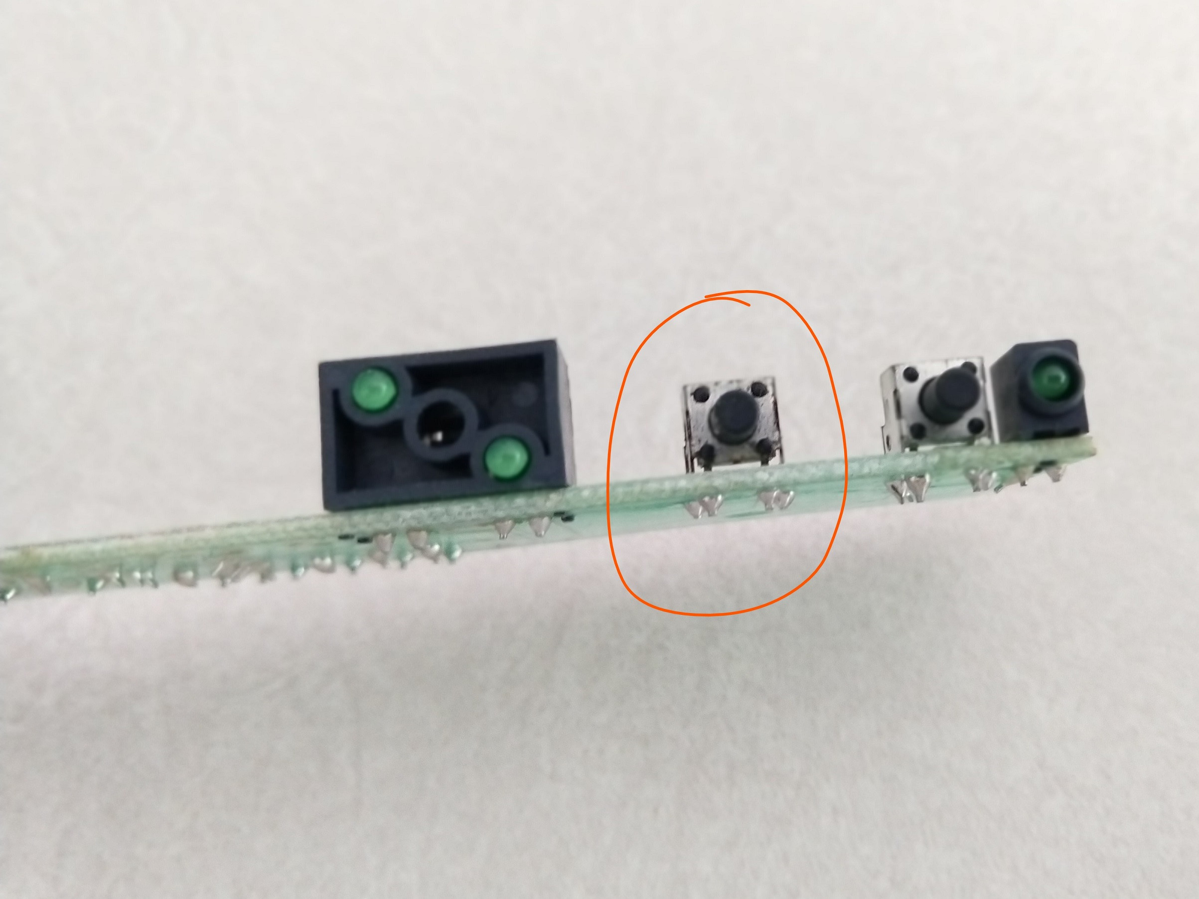 Control board from top with faulty switch circled in orange