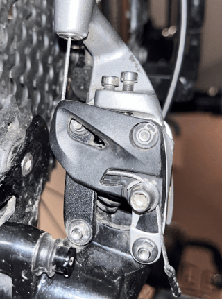 photograph of a SRAM Rival derailleur's cable routing through the clamp when on the highest gear