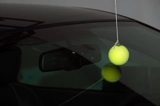 Tennis ball touching windshield