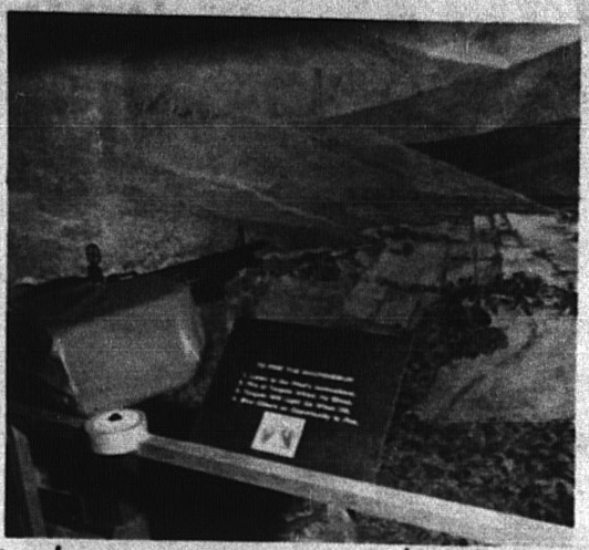 A machine gun, a museum plaque, and a model valley