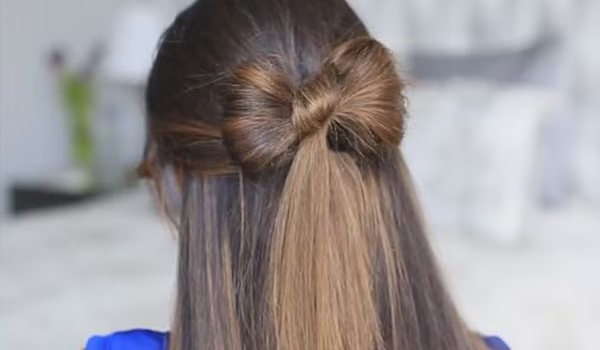 back of a woman's head showing her hair made into a bow shape