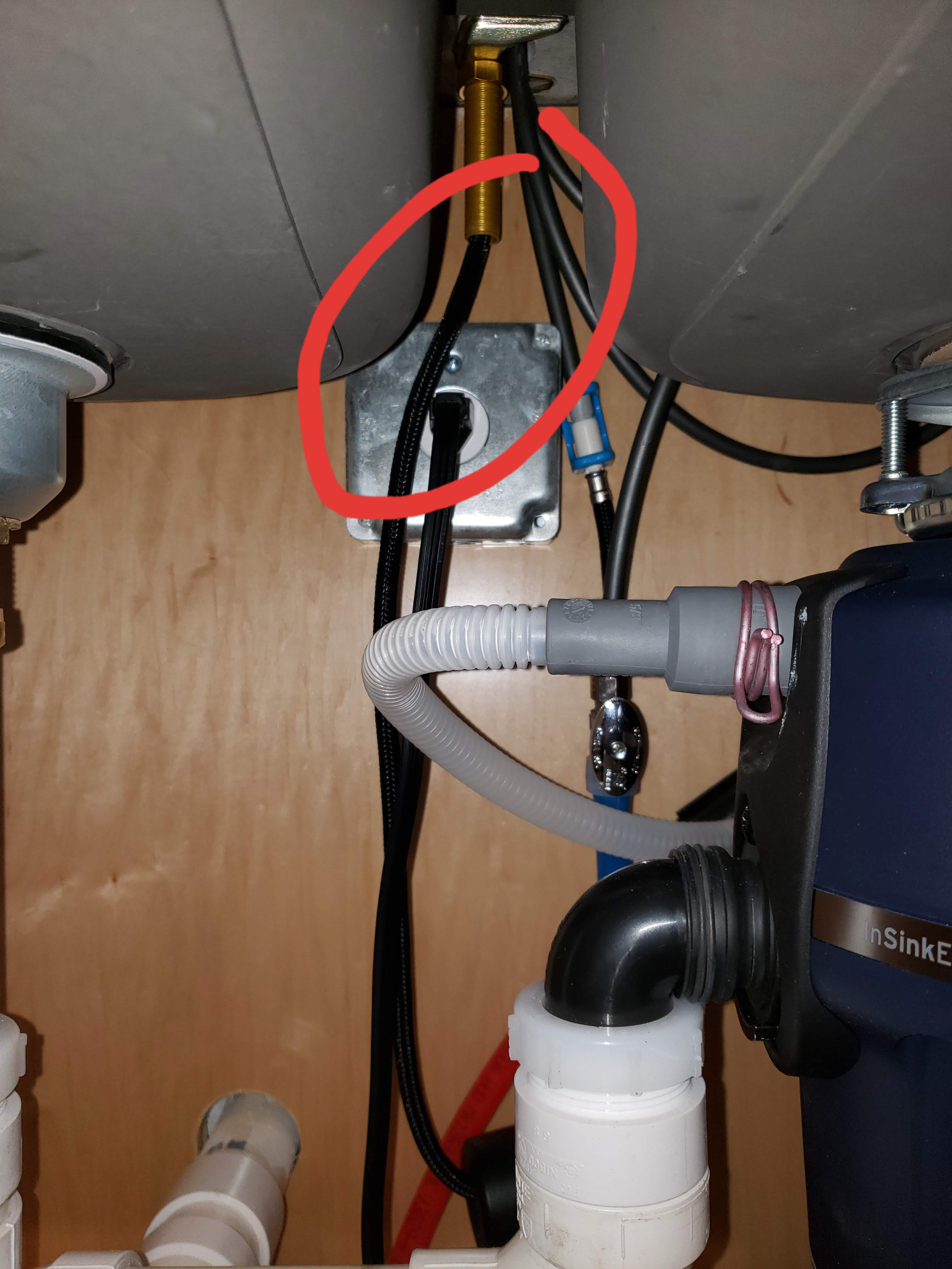 Pic of under-sink, where hose rubs against outlet