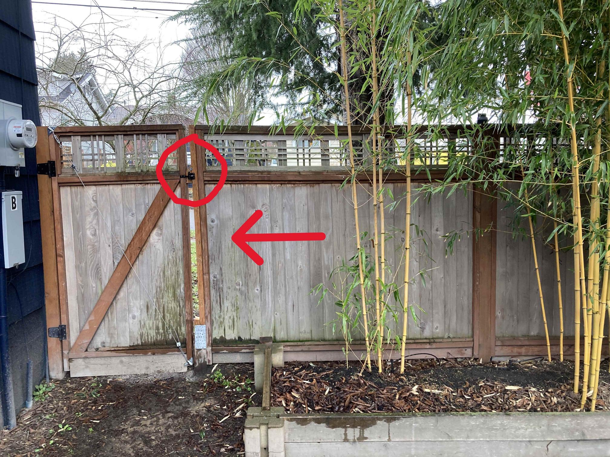 Fence leans in direction of red arrow