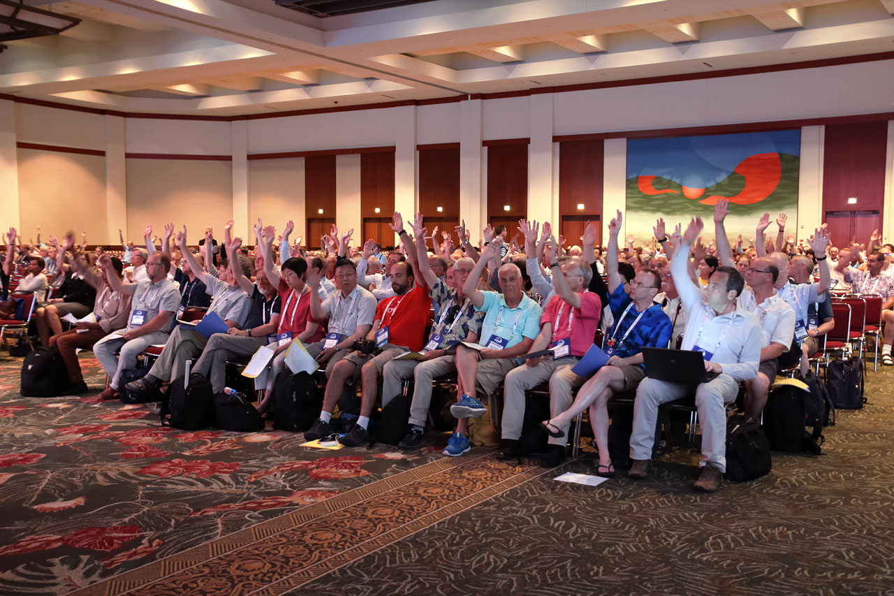 Voting session of the 2015 IAU General Assembly; a small number of people in a much smaller room than the opening session