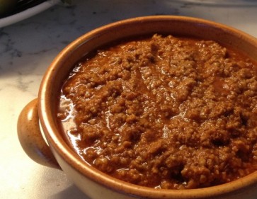 image: terracotta pot of ragù