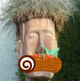 moai-shaped flowerpot with a bûche de noël that is much too big for its mouth