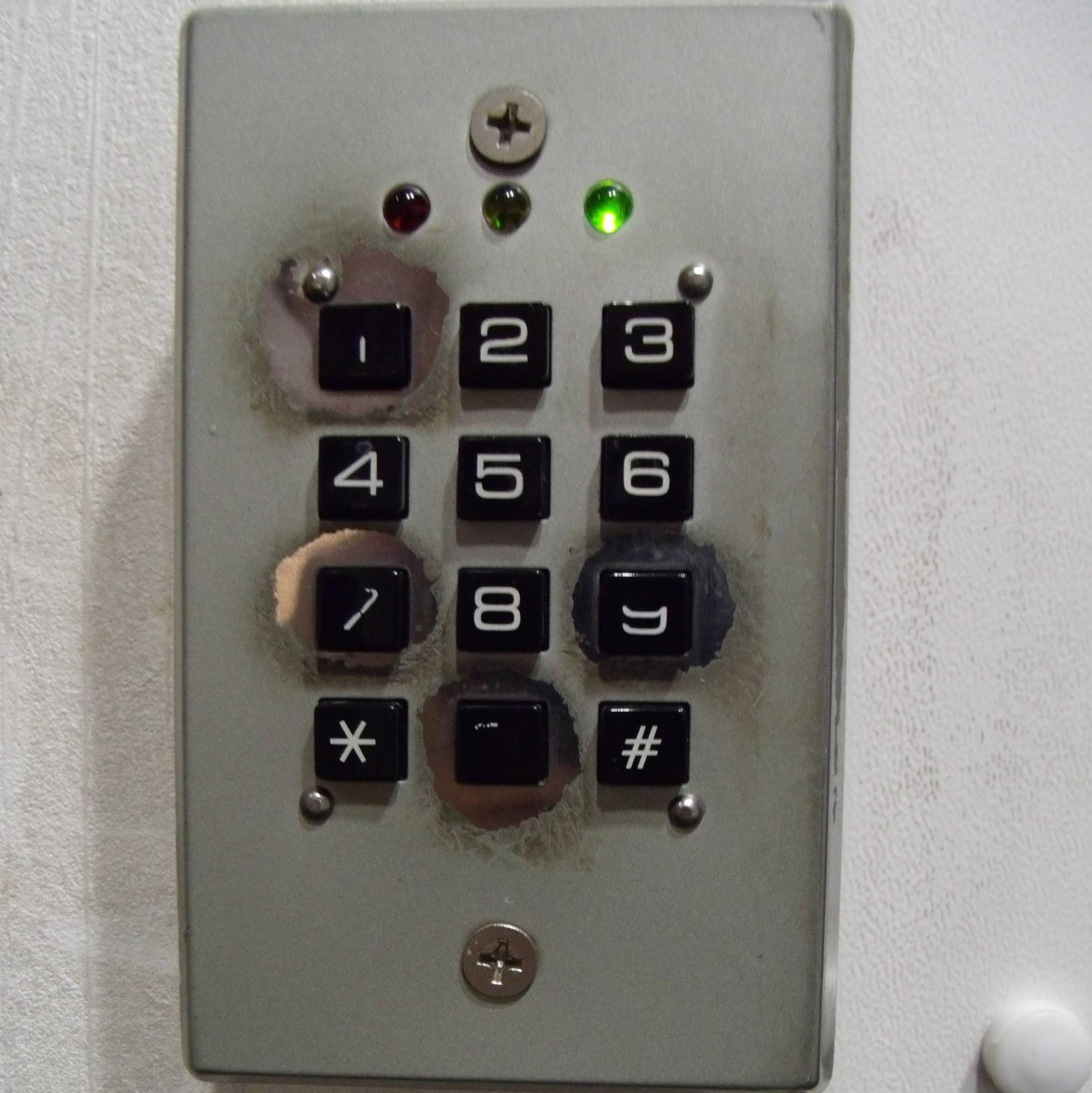 Picture of an electronic keypad with the numbers 0, 1, 7 and 9 looking especially worn down