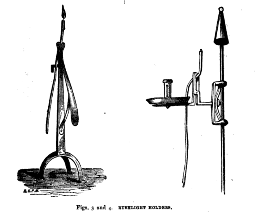 Two rushlight holders designed to hold rushlights upright. Both look like candlesticks.