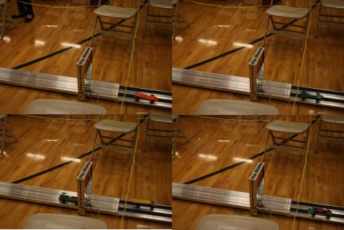 Four images of the finish line of a pinewood derby track, each with one car slightly blurred about a foot after the finish line.