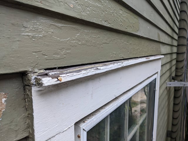 100 year old window with rotting flashing