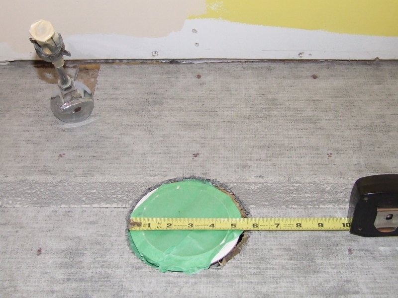 Concrete boards dry fit on floor with toilet pipe