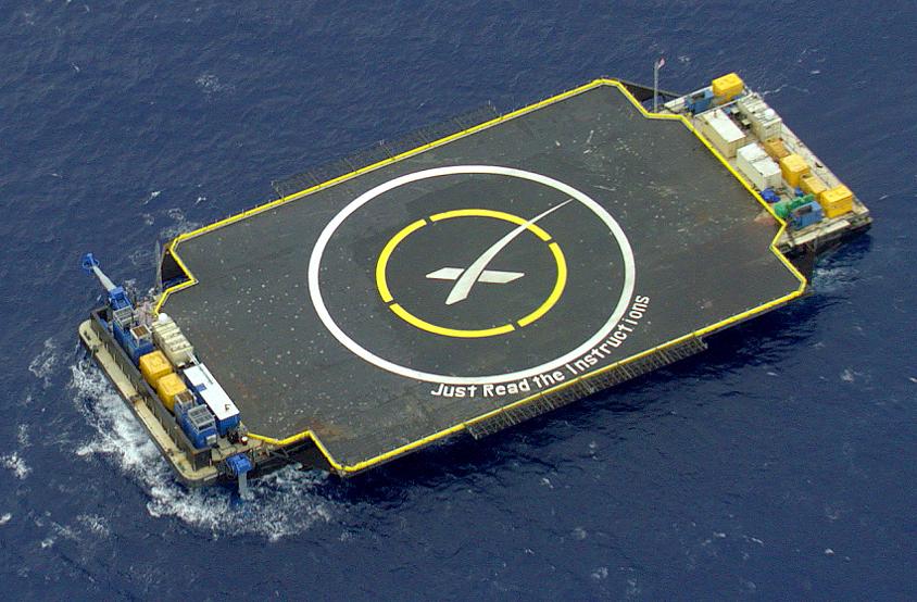 Aerial view of the drone ship Just Read the Instructions, showing its name on the deck