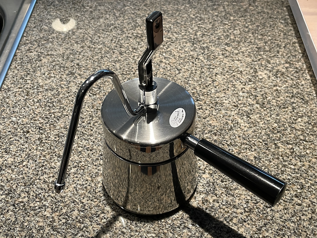 A stovetop coffee maker with the valve open