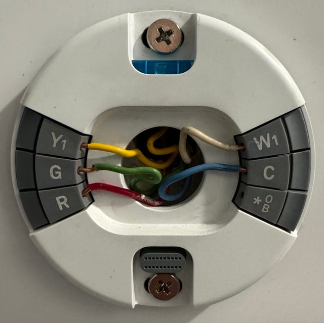 Image of Nest thermostat wiring showing C, G, R, Y1, and W1 wired with blue, green, red, yellow, and white wires, respectively.