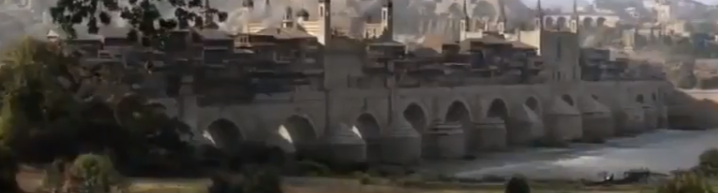 A shot of the bridge with it's 13 arches and buildings standing on top of it, Volantis is seen in the background