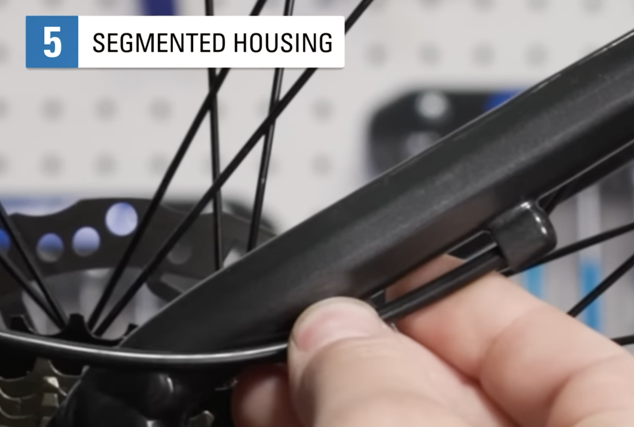 screenshot from Park Tool's video "How to Size and Install Shift Cable Housing" showing a housing stop on a bike frame