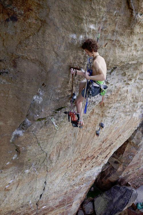 Adam Ondra placing a bolt