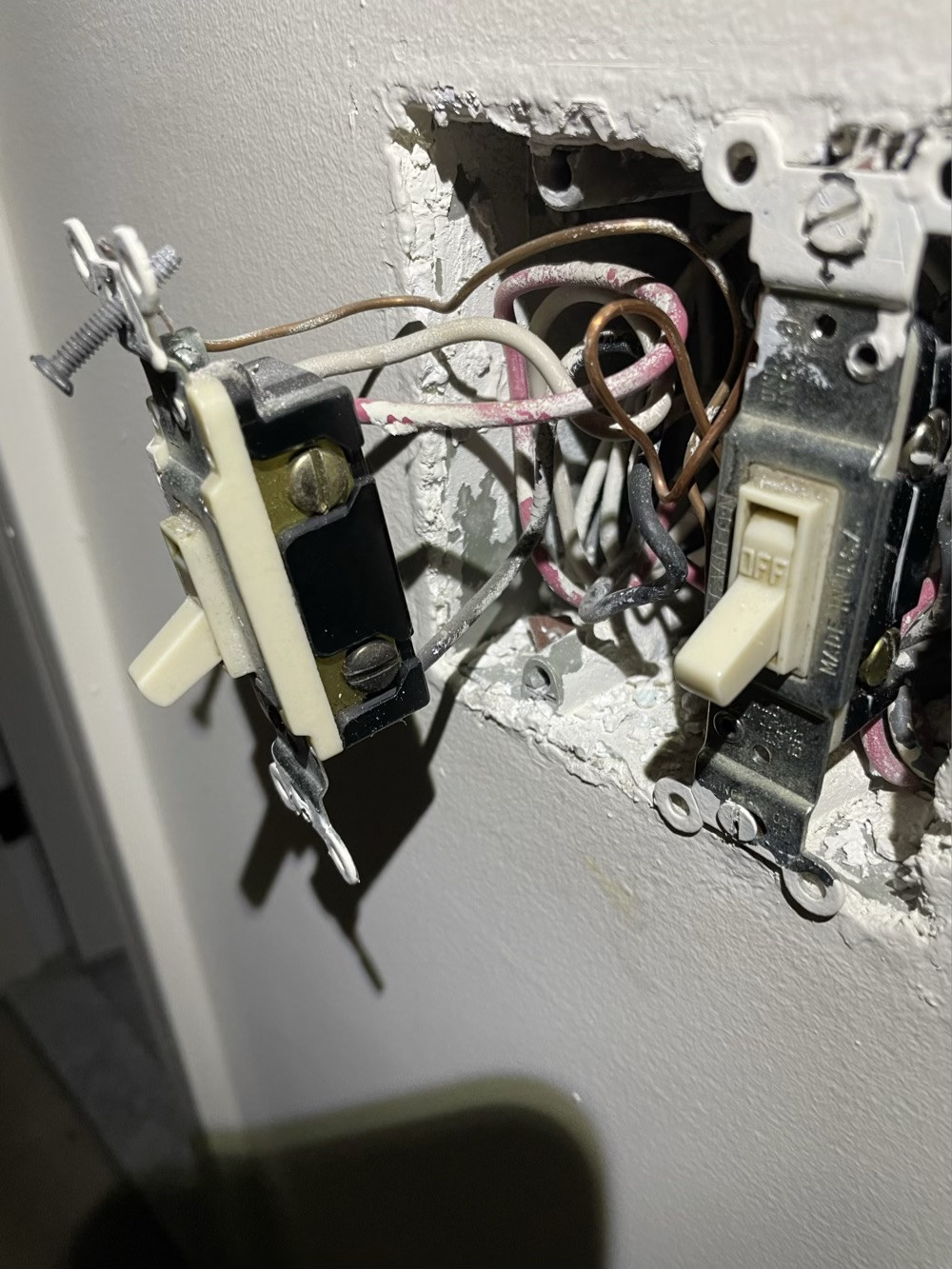 One part of the three way switch, with the one pole switch for the laundry lights beside it