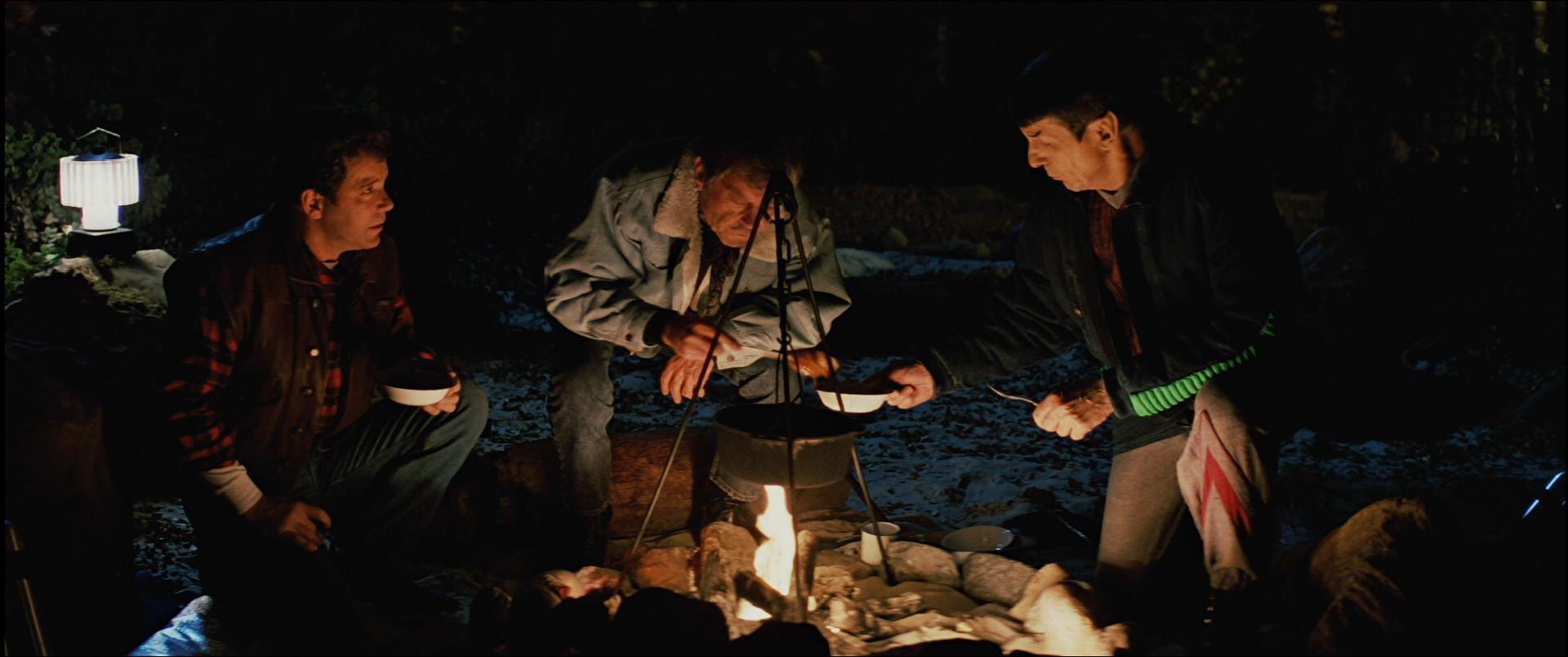 Kirk, Spock, and McCoy gathered around a camp fire in Yosemite National Park.