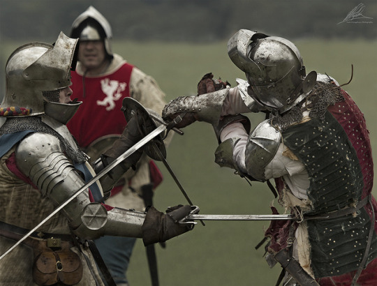 reenactment of knights in armor fighting with swords