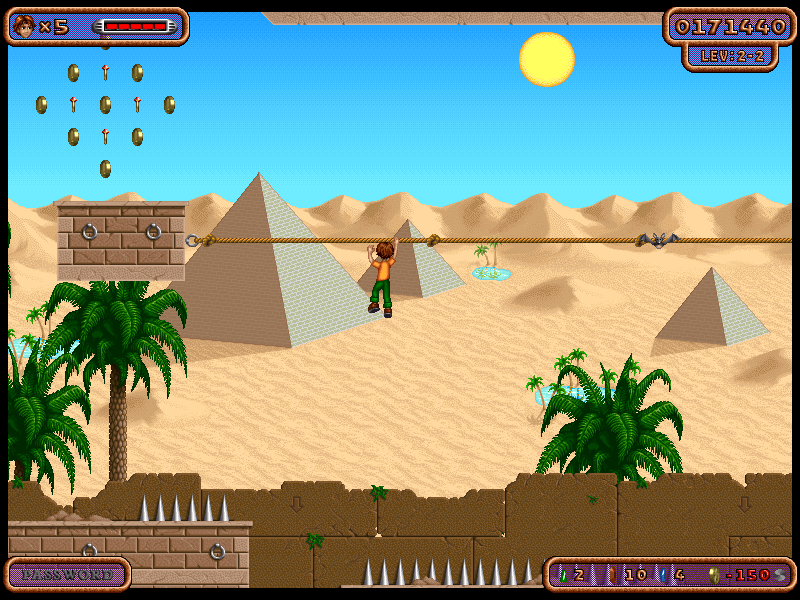 Screenshot from the game showing the playable character hanging from a rope. The game background shows a dessert with pyramids.