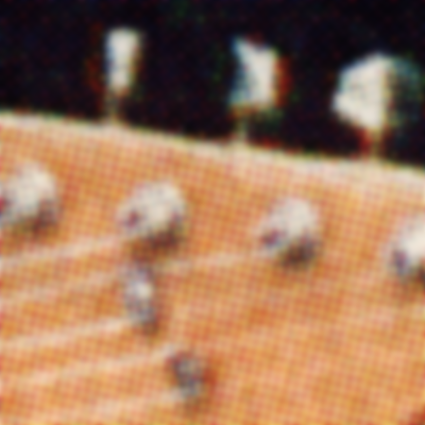 A blured picture of the same guitar, with visible grid patterns