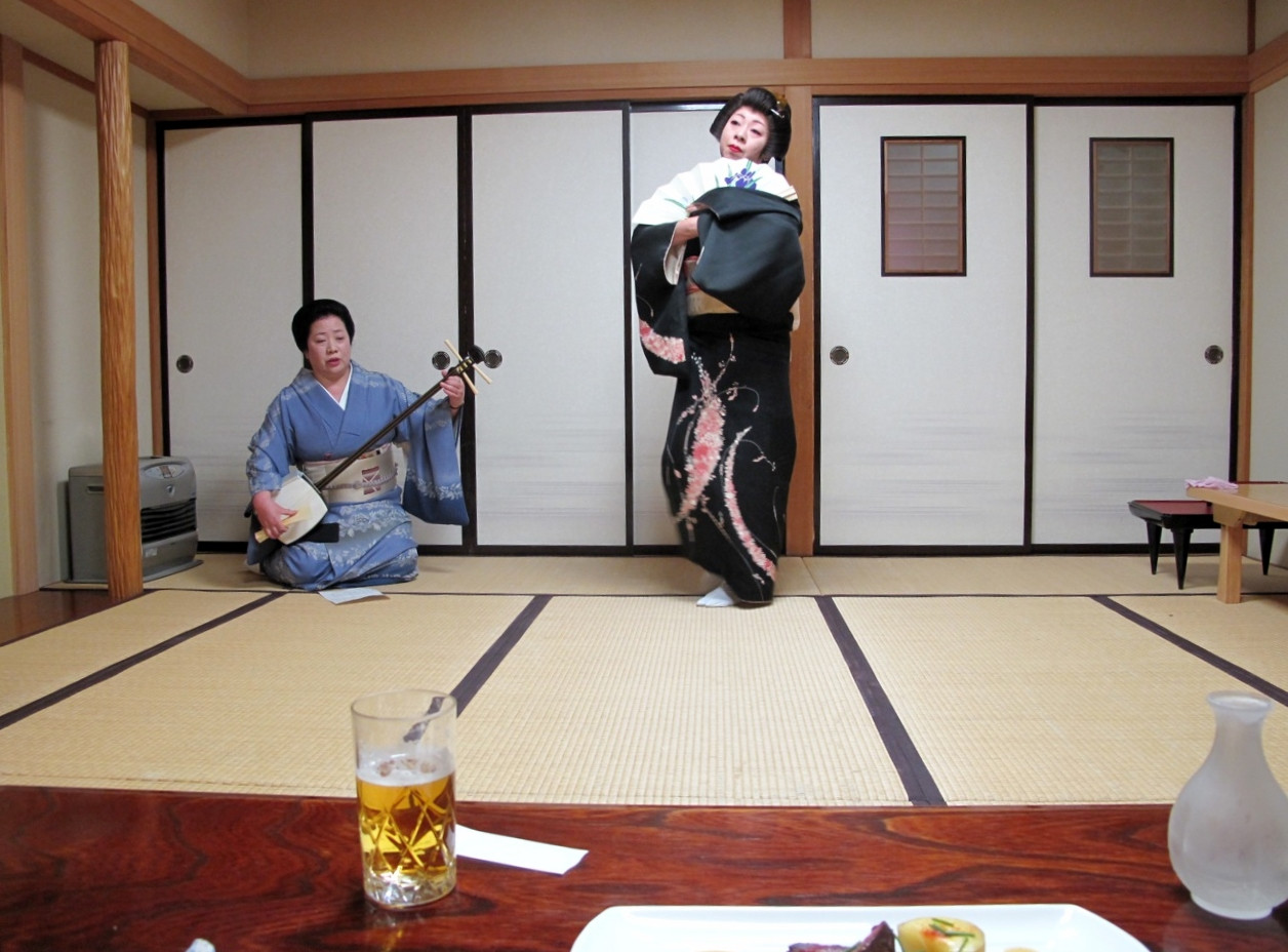 younger geisha dancing, while the elder geisha played the shamisen