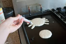 spider-shaped pancake being drawn with syringe