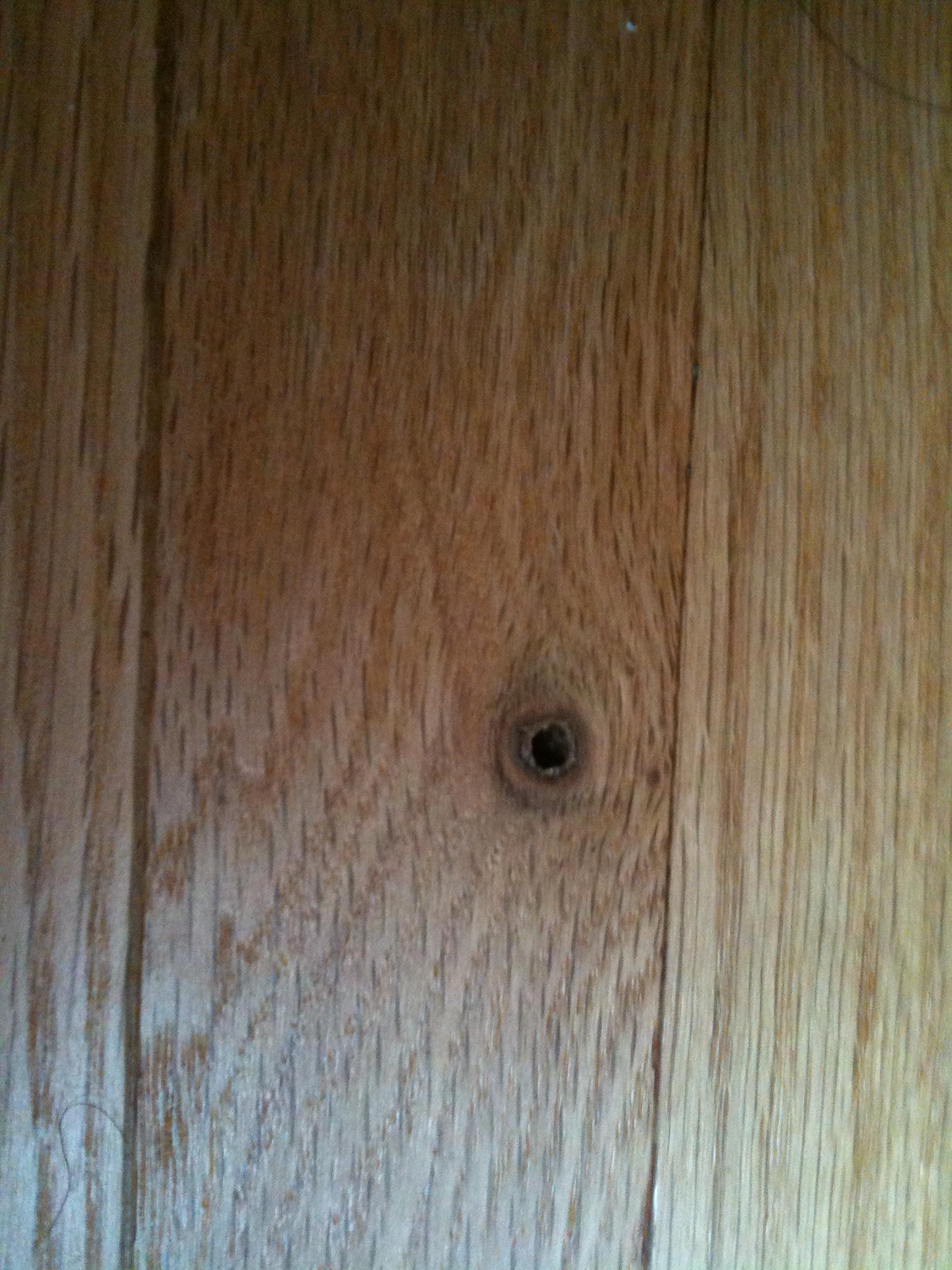 Black hold on hardwood floor