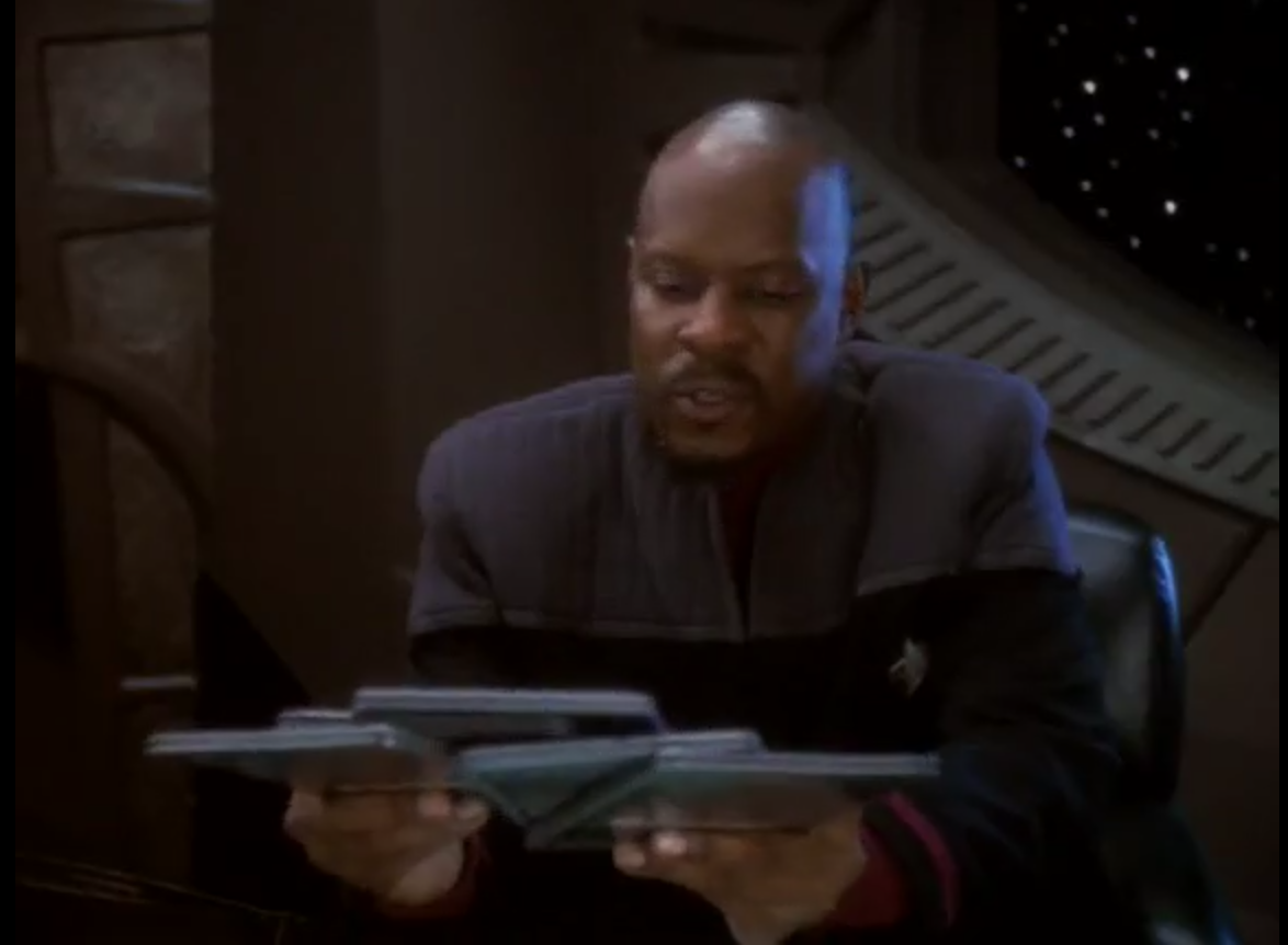 Sisko with pads handed to him one-by-one by Bashir